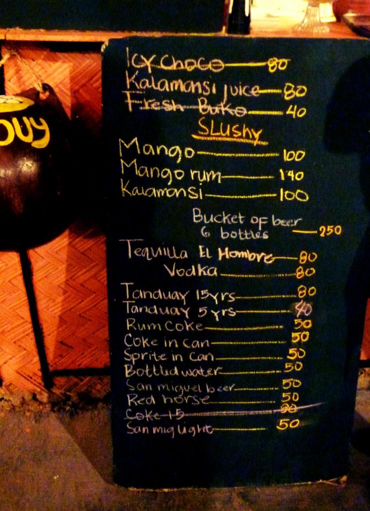 Chalkboard drinks menu in Coron listing juices, mango slushies, beer and spirits with prices