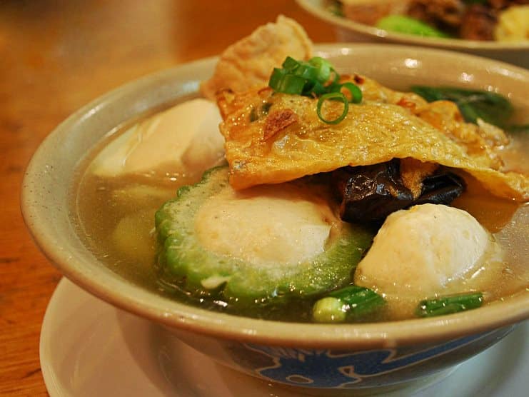 Bowl of yong tau foo soup with tofu, fish balls, bitter gourd and fried skin.