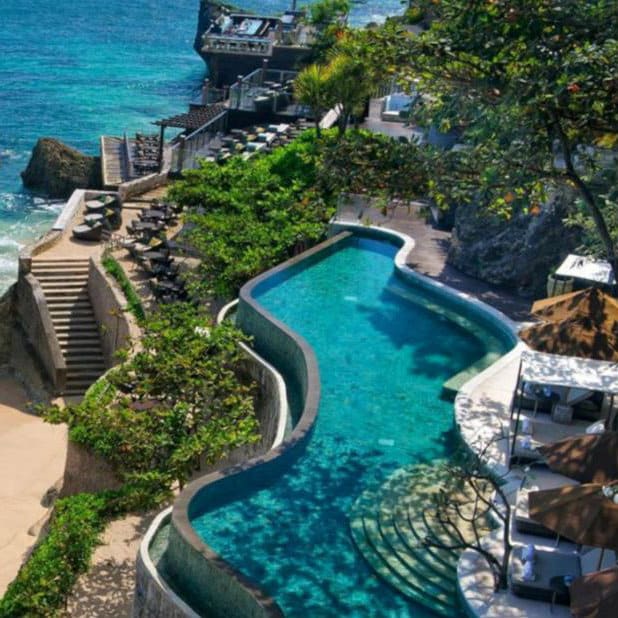 Curved clifftop pool above the turquoise sea at AYANA Resort and Spa in Bali.