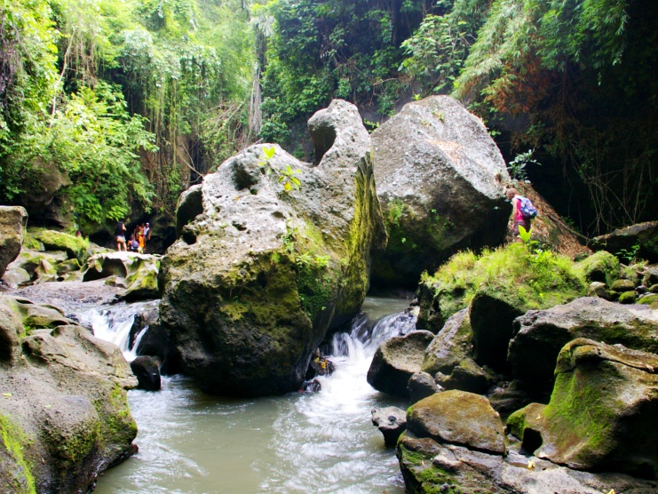 Water flowing between huge boulders in the jungle-walled Hidden Canyon in Bali.