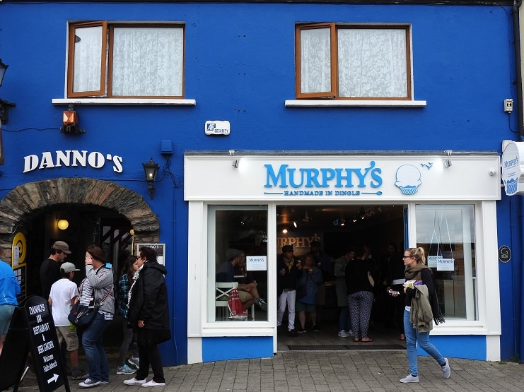 A queue outside Murphy's ice cream shop on a bright blue shopfront in Dingle, Ireland.