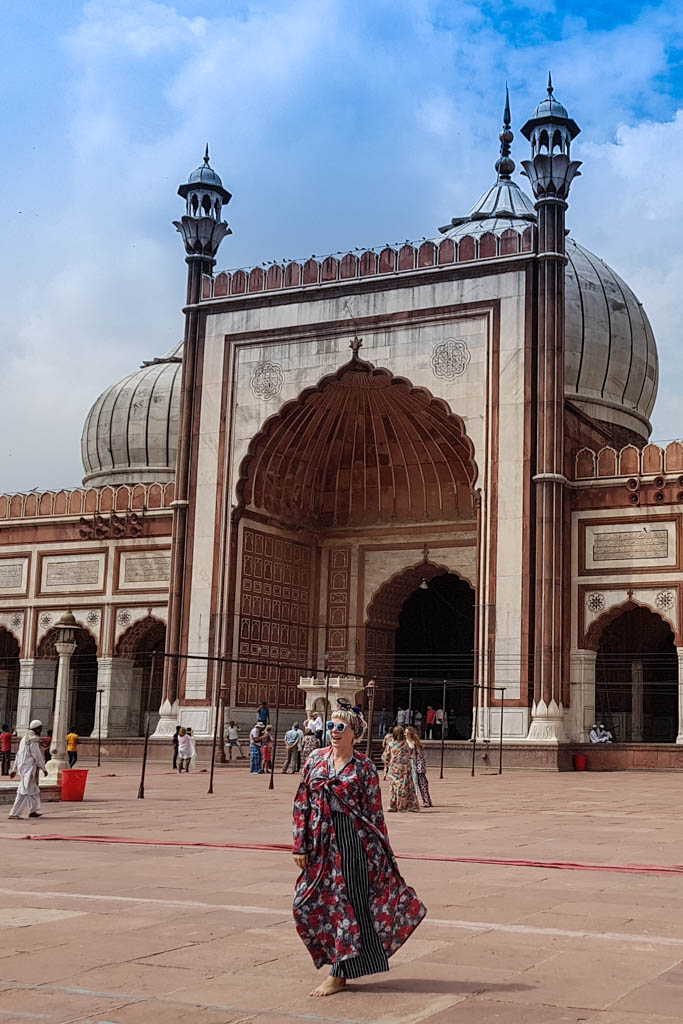 Alice in a floral robe crosses the courtyard of the Jama Masjid mosque in Delhi.