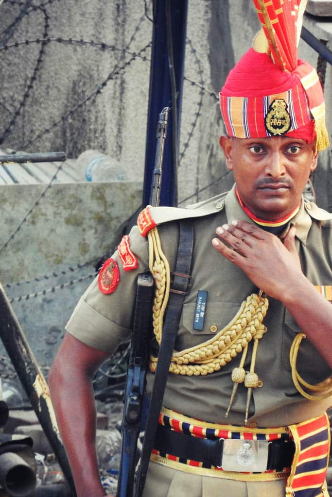An Indian border guard in a red plumed turban and dress uniform at the Wagah border.