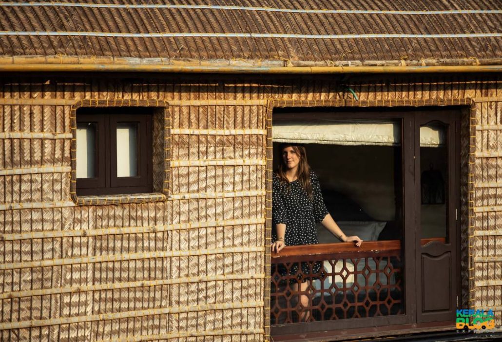 Alice looks out from the window of a woven-cane Kerala houseboat in Alleppey, India.