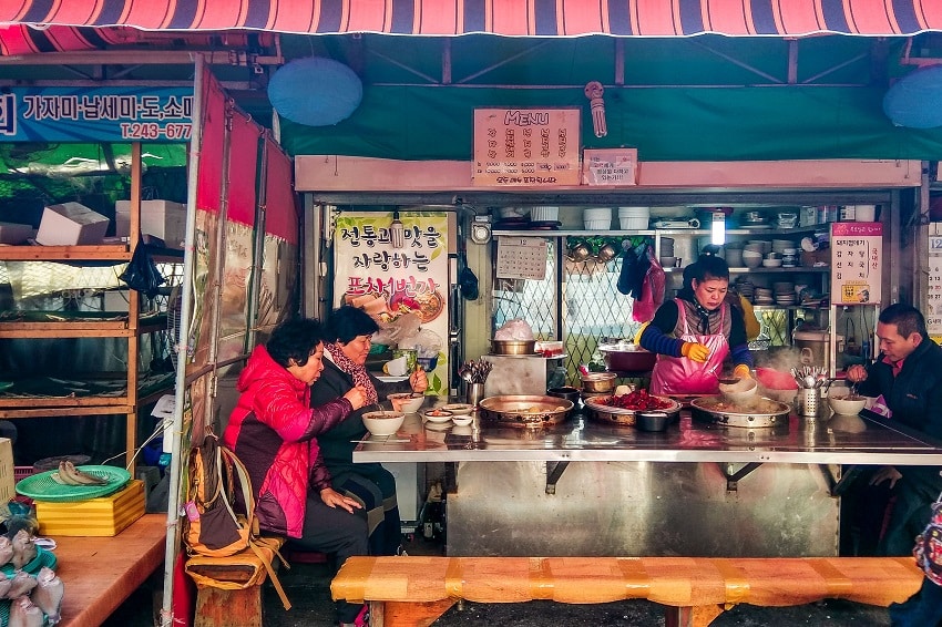 Korean ladies eating fish soup on an outside stall at Jalgachi Fish Market